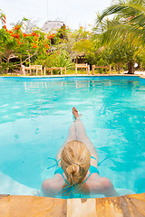 Image showing Caucasian lady floating in swimming pool.