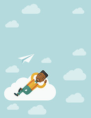 Image showing Black man lying on a cloud with paper plane.