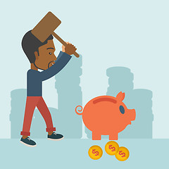 Image showing Black guy holding a hammer breaking piggy bank.