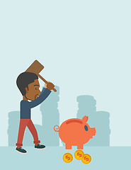 Image showing Black guy holding a hammer breaking piggy bank.