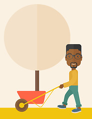 Image showing Young african man pushing the cart with tree.