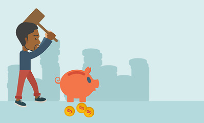 Image showing Black guy holding a hammer breaking piggy bank.