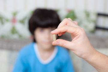 Image showing doctor with pill and boy