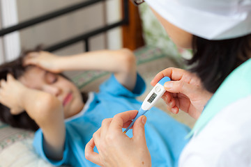 Image showing digital thermometer in the hands of a doctor. Temperature measur