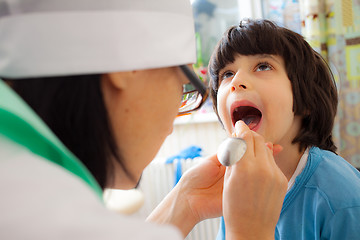 Image showing boy showing his throat to doctor