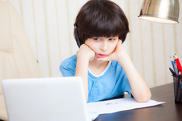 Image showing boy looks thoughtfully at the display