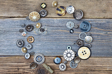 Image showing several old buttons on the vintage table surface