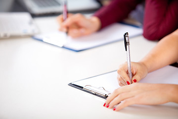 Image showing woman holding a written examination