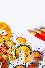 Image showing set of colored pencils and shavings on white