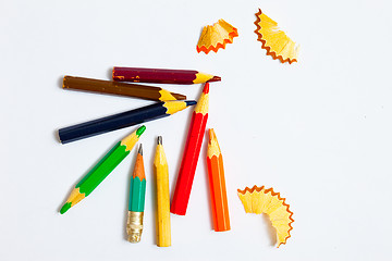 Image showing several vintage pencils and shavings on a white