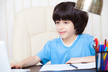 Image showing boy doing homework with computer