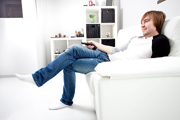 Image showing smiling  man  with remote control tv