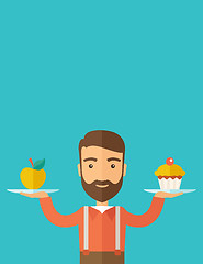 Image showing Man carries with his two hands cupcake and apple.