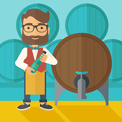 Image showing Wine maker inspecting wine from barrel.