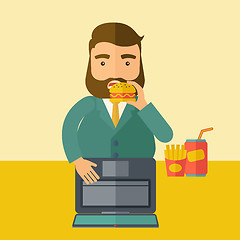 Image showing Young fat guy eating while at work.