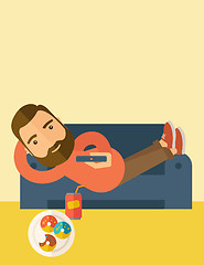 Image showing Man lying in the sofa holding a remote.