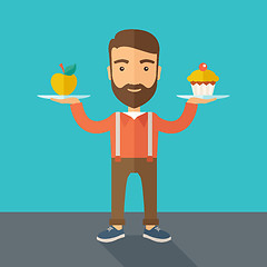 Image showing Man carries with his two hands cupcake and apple.