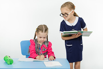 Image showing Girl student teacher dictating dictation