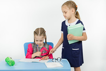 Image showing Girl teacher found a mistake in the student notebooks