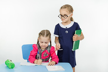 Image showing Girl teacher supervises the job apprentice