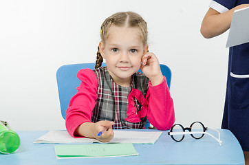 Image showing Charming schoolgirl at the desk