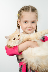 Image showing Portrait of cheerful four-year girl with a cat in her arms