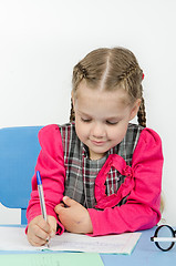 Image showing Schoolgirl wrote in a notebook