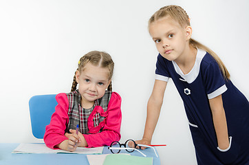 Image showing The teacher leaned on table student