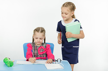 Image showing Girl teacher during task checks correctness of its implementation