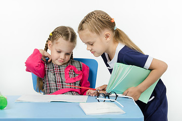 Image showing Girl teacher checks written by a disciple