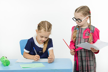 Image showing Privlezhnaya pupil under the supervision of a strict teacher