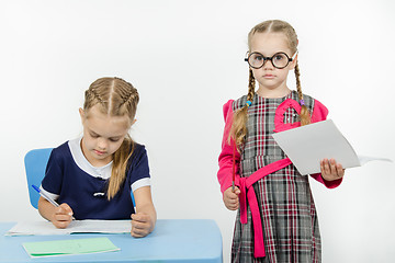 Image showing Severe teacher standing at the student