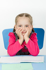 Image showing Portrait of a pensive pupil at school desk