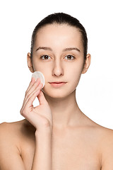 Image showing skin care woman removing face with cotton swab pad