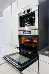 Image showing Modern hi-tek kitchen, oven with door open