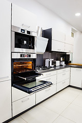 Image showing Modern hi-tek kitchen, oven with door open