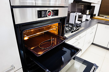 Image showing Modern hi-tek kitchen, oven with door open