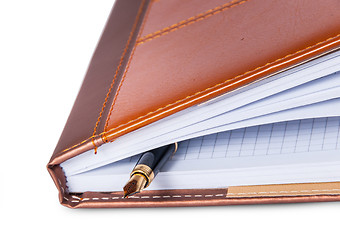 Image showing Closeup fountain pen located inside the notebook