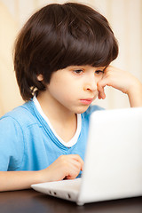 Image showing child looking at a computer monitor
