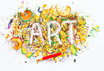 Image showing art word on the background of bright colored pencil shavings