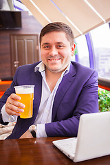 Image showing smiling businessman with beer