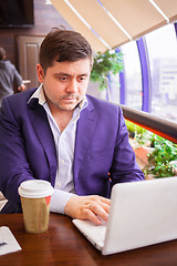 Image showing businessman working on a computer