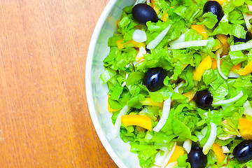 Image showing Assorted salad of green leaf lettuce with squid and black olives