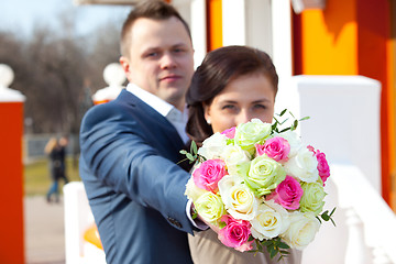 Image showing bride and groom with bouquet