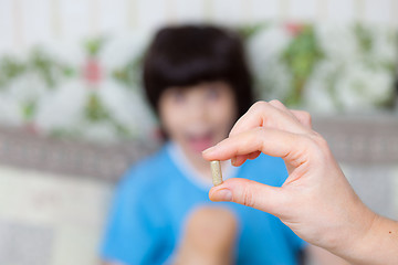 Image showing hand of a doctor with pill