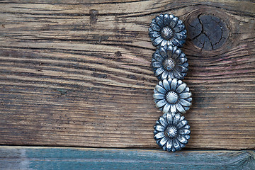 Image showing four vintage buttons on wooden boards