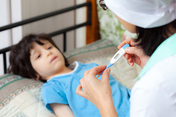 Image showing digital thermometer in the hands of a doctor