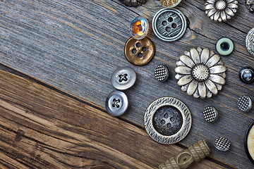 Image showing vintage buttons on the aged wooden boards