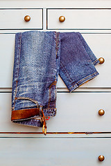 Image showing old Jeans protrudes from the drawer