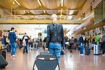 Image showing Female traveller walking airport terminal.